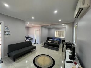 Modern living room with smooth, painted walls achieved through drywall plastering, enhancing the room's aesthetics and durability.