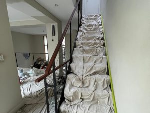 stairs covered for protection during the plastering internal walls process.