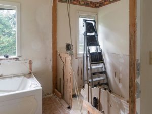 Partially demolished bathroom with exposed walls, highlighting the risk of asbestos in bathroom construction materials during renovation.