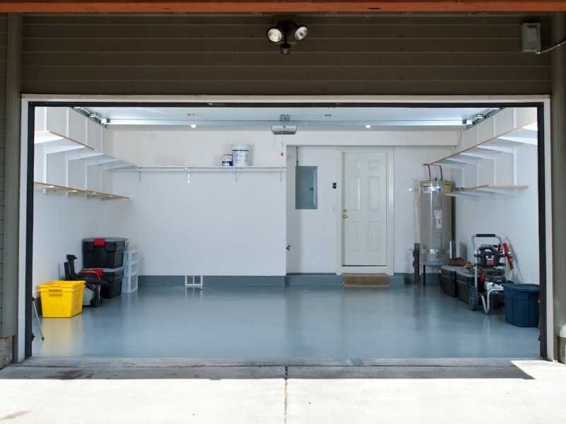 Freshly painted garage interior with organised shelves after garage painting.