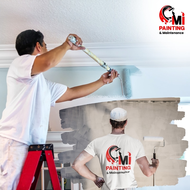 A painter in Yattalunga applies a light blue coat to a ceiling, standing on a ladder, while another painter rolls wall paint, showcasing their team logo.