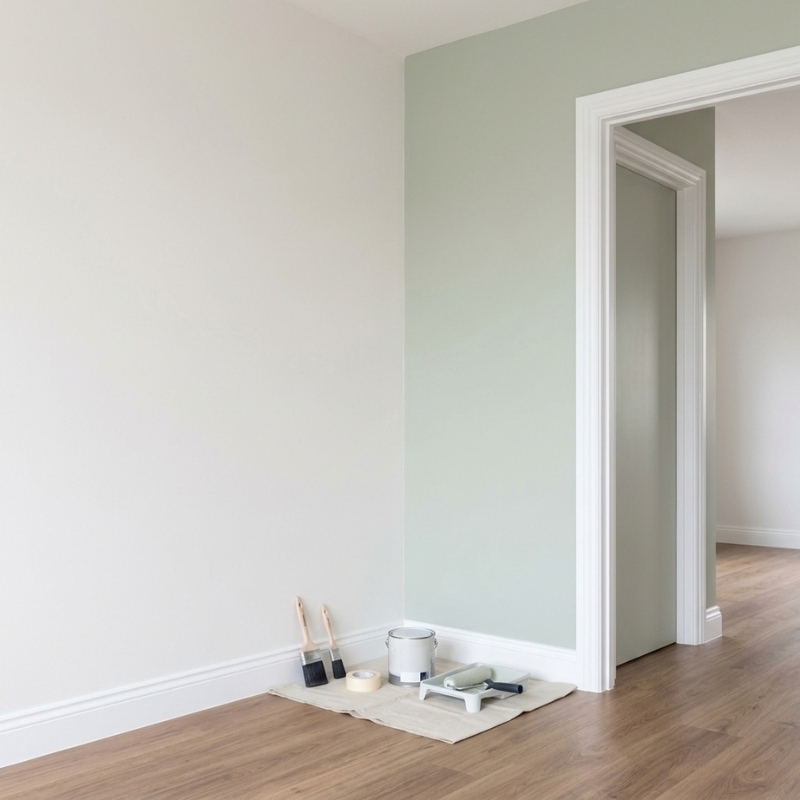 Painter and decorator working on a feature wall with smooth finishes and detailed trim in a modern Sydney home
